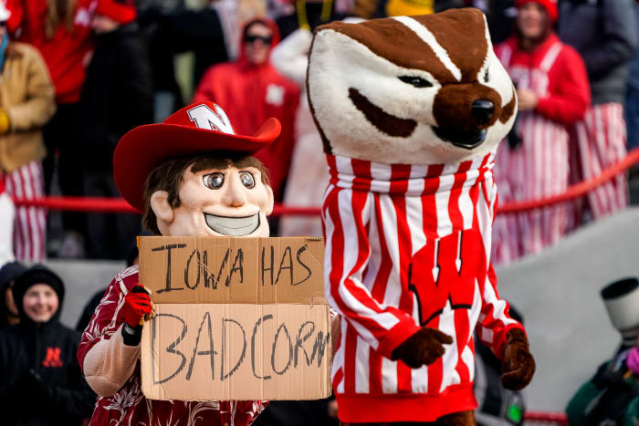 Nov 19, 2022; Lincoln, Nebraska, USA; Herbie Husker and Bucky Badger pose with a Iowa has bad corn sign during the game between the Nebraska Cornhuskers and the Wisconsin Badgers at Memorial Stadium. Mandatory Credit: Dylan Widger-USA TODAY Sports